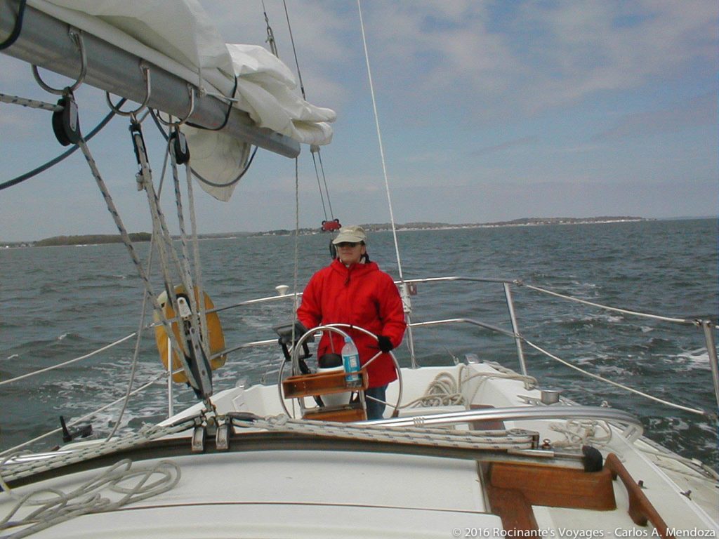 The Admiral at the helm as we head out of Milford Harbor - perfect sailing weather!