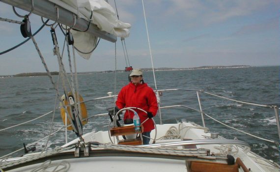 The Admiral at the helm as we head out of Milford Harbor - perfect sailing weather!